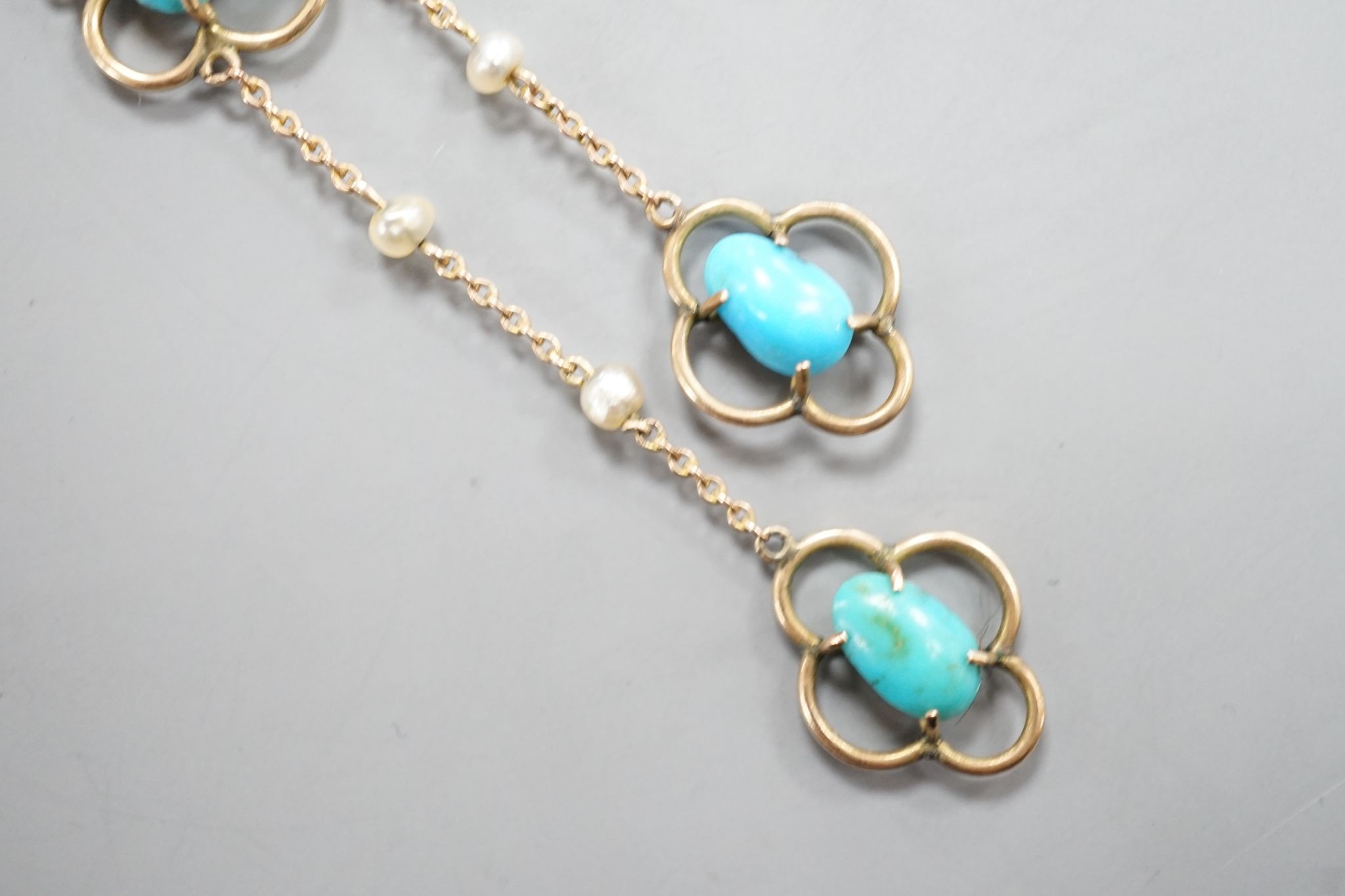 An Edwardian 9ct , three stone turquoise and three stone seed pearl set graduated double drop pendant necklace, 50cm, gross weight 3.1 grams.
